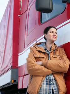 woman standing in front of truck with arms crossed