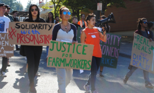 young people walking with signs calling for justice