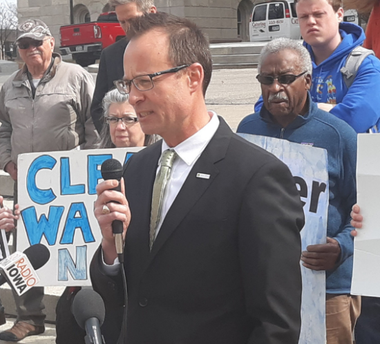 Attorney Brent Newell speaks in from of clean water rally in Des Moines Iowa