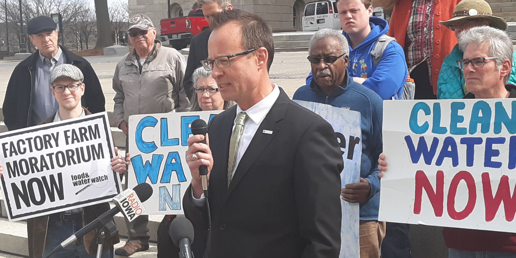 Attorney Brent Newell speaks in from of clean water rally in Des Moines Iowa