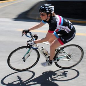 A woman racing a road bicycle.